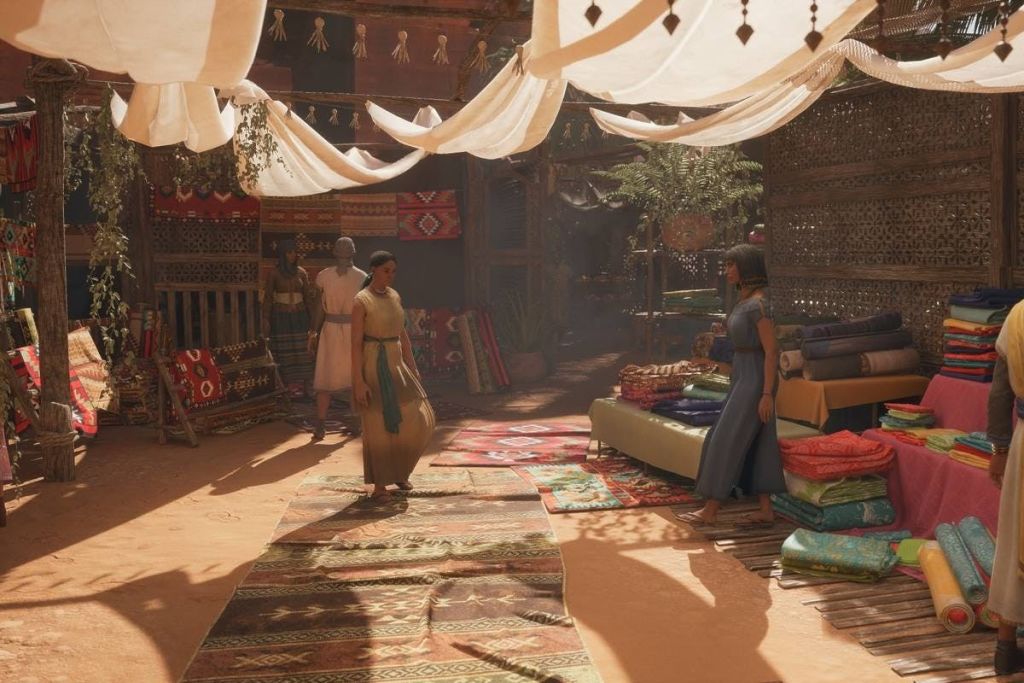 천으로 된 캐노피 아래에서 사람들과 함께 마켓을 즐겨보세요. 바닥에 러그를 깔고 낮은 테이블에 원단을 전시합니다.