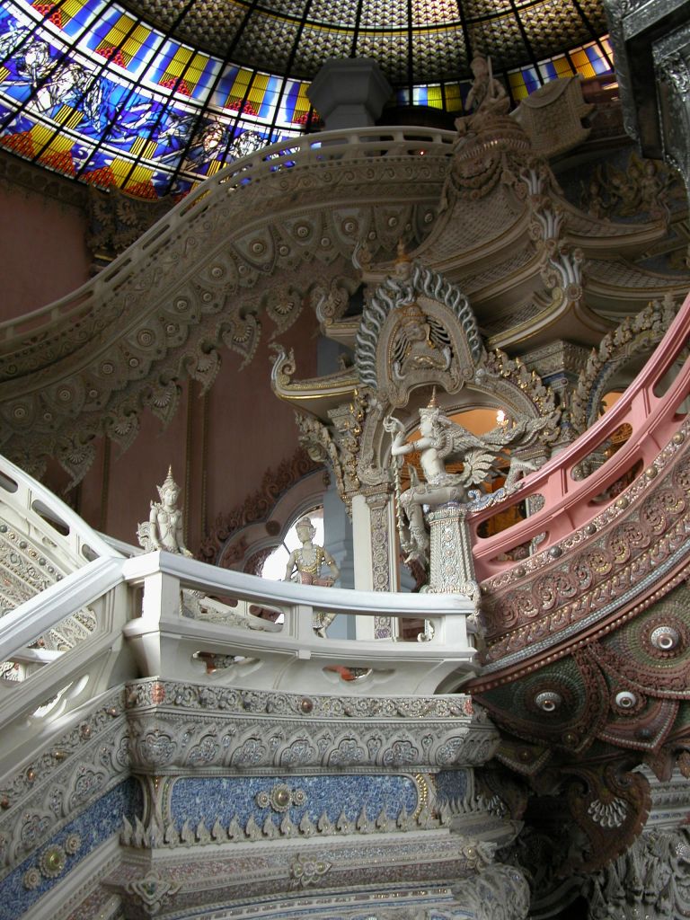 스테인드글라스 돔 아래 조각된 형상과 호화로운 디자인이 돋보이는 화려하고 정교하게 장식된 계단.