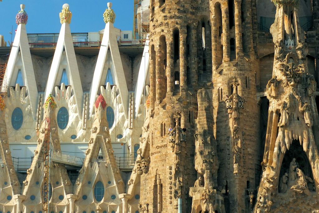 사그라다 파밀리아 (Sagrada Família) 의 정교한 석조물과 첨탑을 클로즈업하여 세밀한 조각과 건축 요소를 보여줍니다.