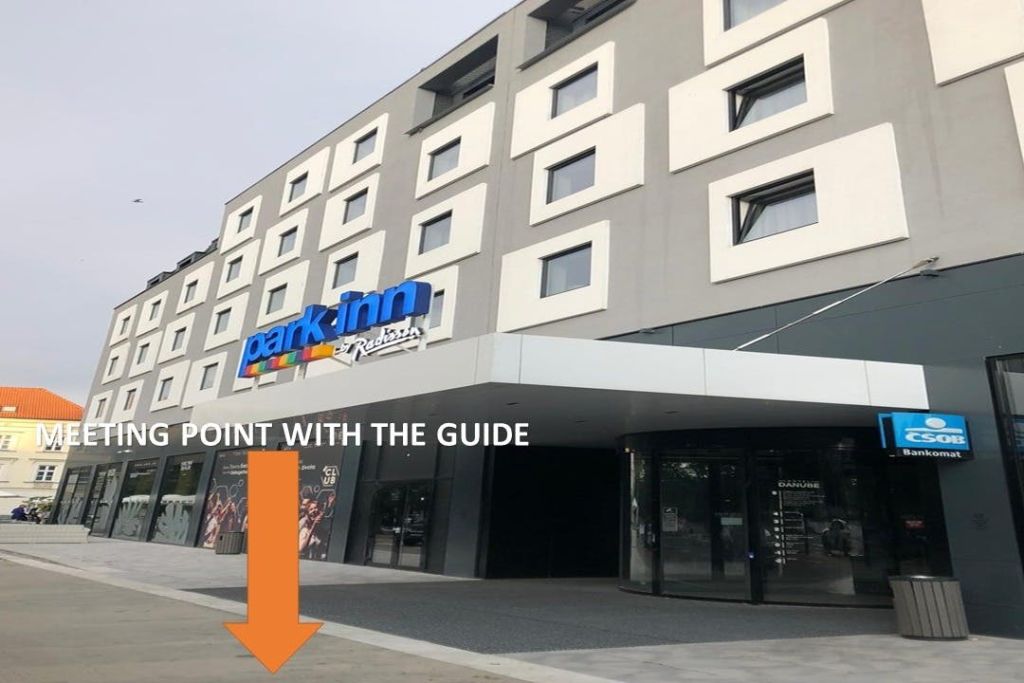 현대적인 호텔 건물, '파크 인 바이 래디슨 (Park Inn by Radisson)' 로고, 대형 주황색 화살표가 보도에 "가이드와 함께 포인트" 라고 적혀 있습니다.