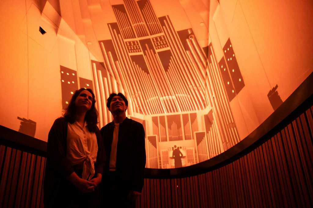 몰입감 넘치는 서라운드 사운드와 시각적 경험을 즐기는 방문객.