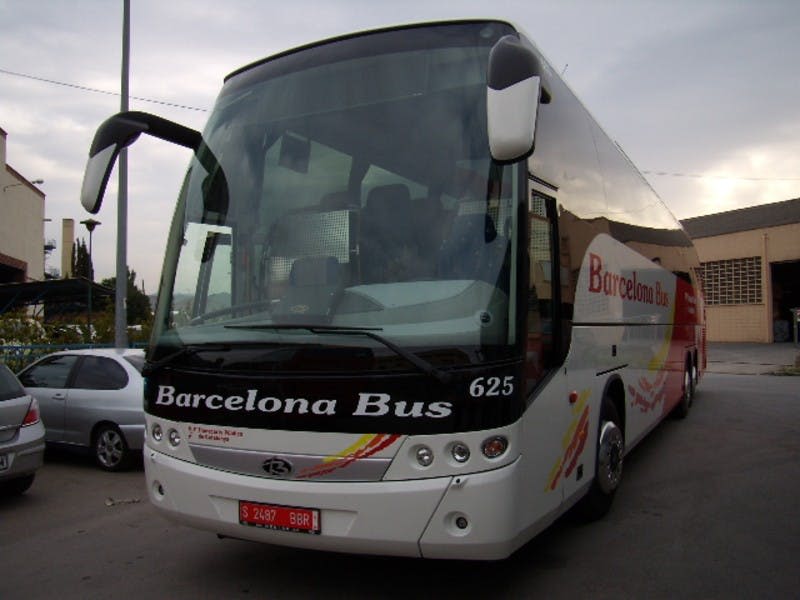앞면과 옆면에 "바르셀로나 버스 625" 가 적힌 대형 흰색 버스가 거리에 주차되어 있습니다.