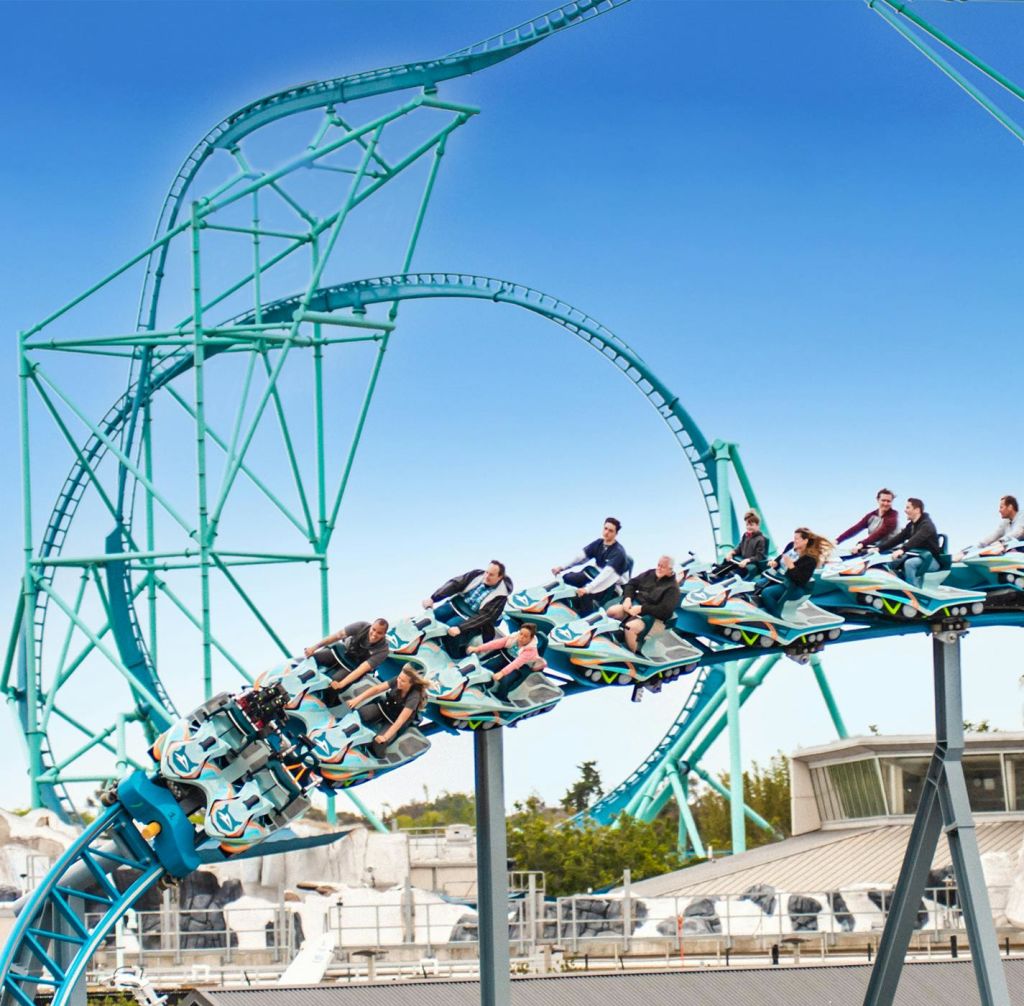 파란색 롤러코스터를 타고 선로를 따라 맑고 푸른 하늘을 바라보며 라이딩을 즐기는 사람들.