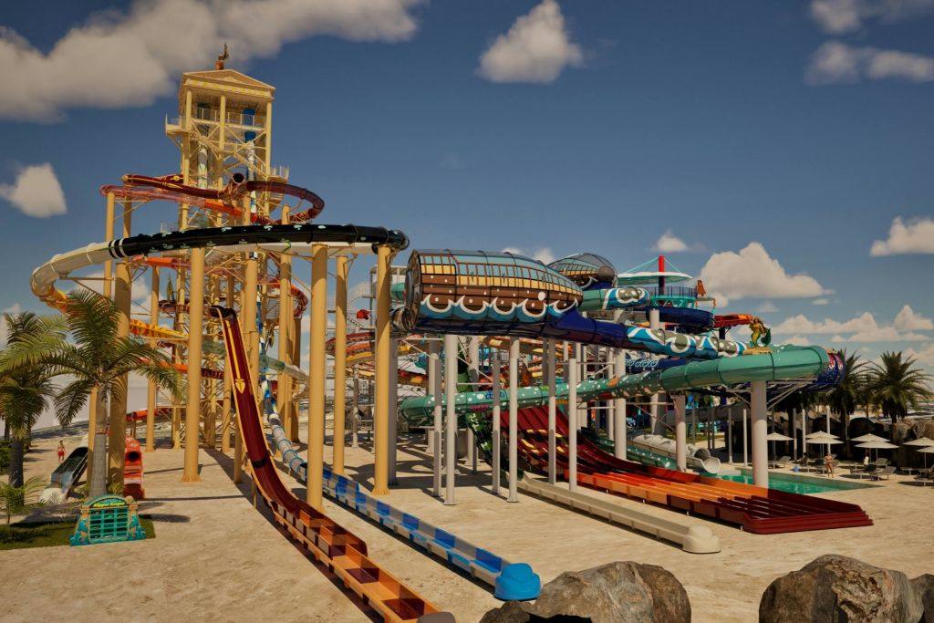 높이 솟은 미끄럼틀, 튜브 타기, 푸른 하늘 아래 놀이 기구가 있는 워터파크.