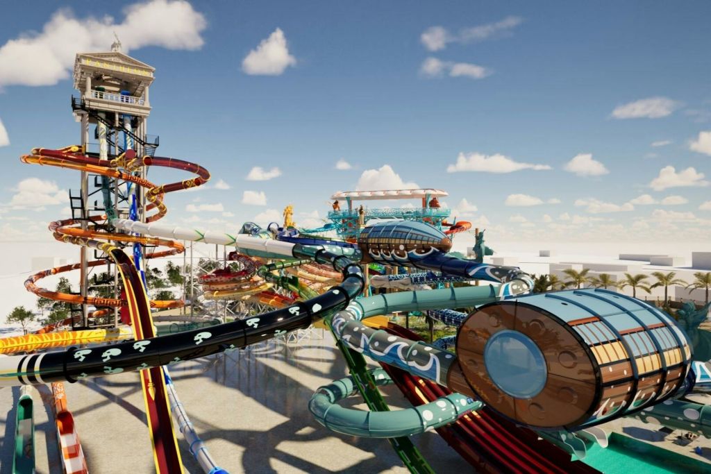 구름이 흩날리는 화창한 푸른 하늘 아래 정교한 미끄럼틀과 구조물이 있는 다채로운 워터파크입니다.