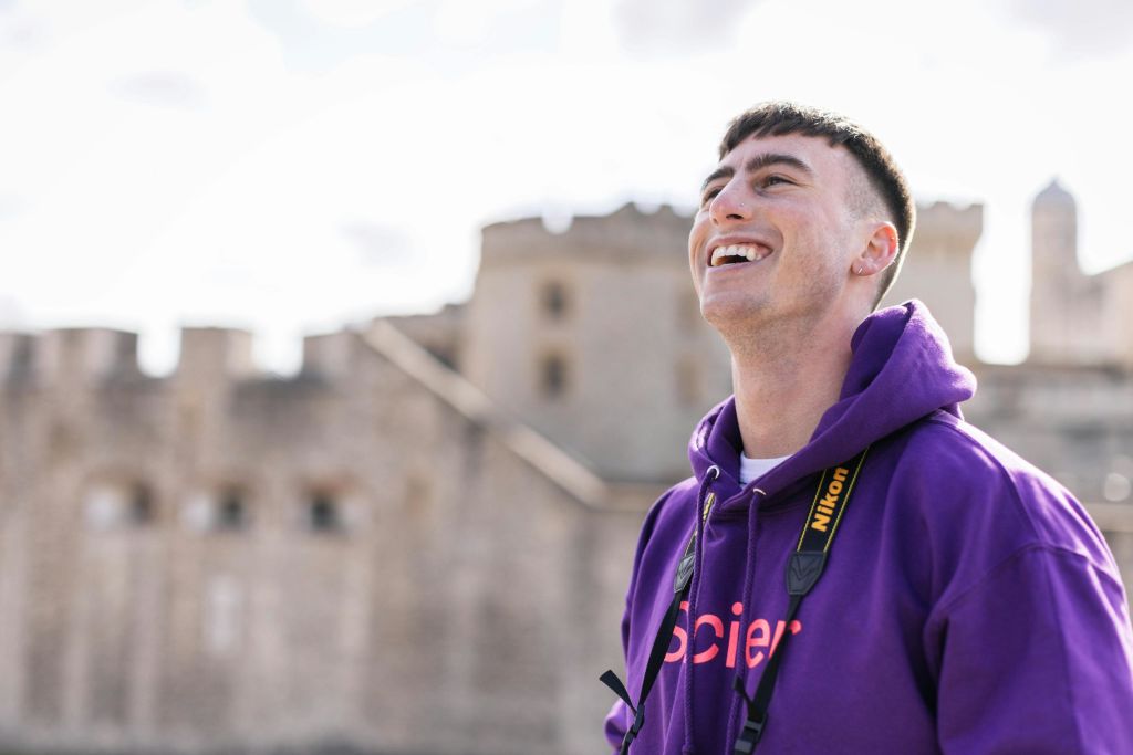 런던 타워 밖에서 사진작가가 미소를 짓고 있습니다.