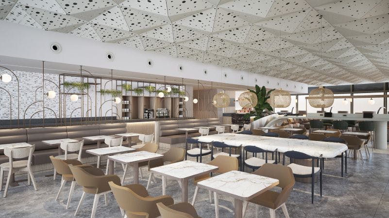 대리석 테이블, 쿠션이 있는 의자, 구형 조명, 천공 패널이 있는 천장, 식물 디스플레이가 있는 현대적인 카페.