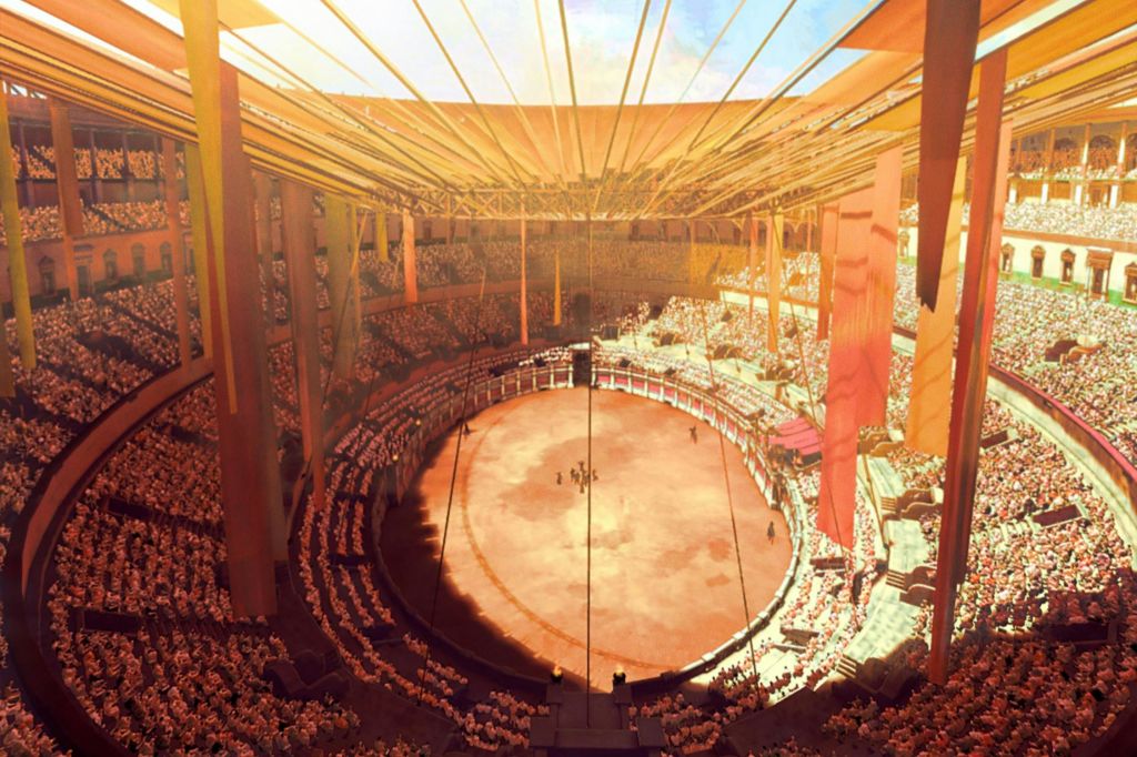 중앙에 커다란 원형 경기장이 있고, 층층이 쌓인 좌석으로 둘러싸여 있으며, 주황색 배너로 장식된 햇살이 비치는 경기장입니다.