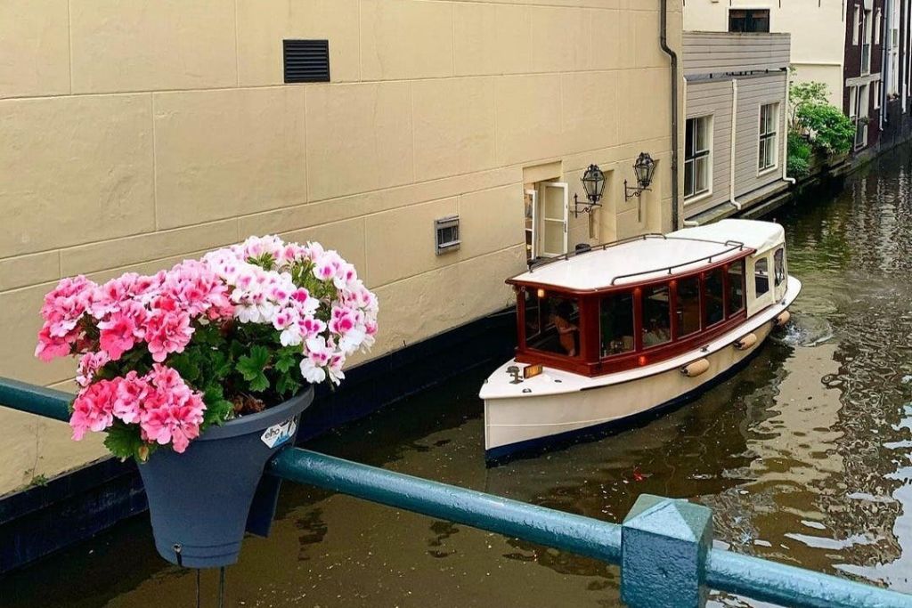 유서 깊은 작은 보트를 타고 암스테르담의 좁은 운하를 따라가는 크루즈