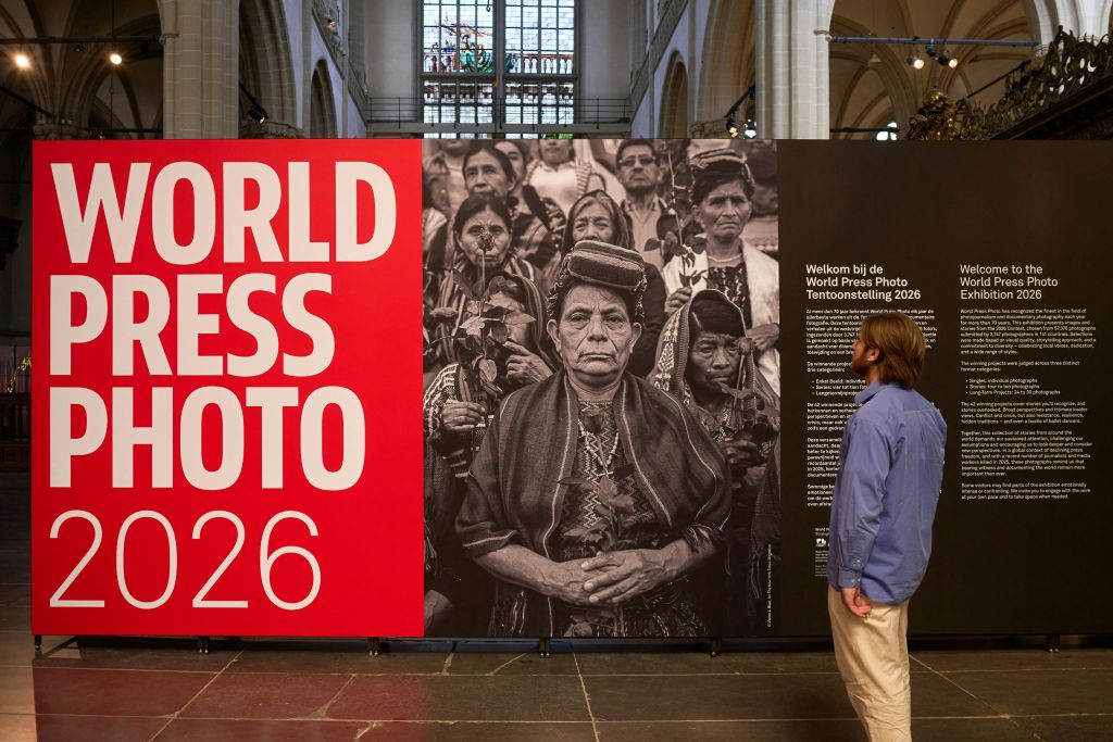 한 사람이 월드 프레스 포토 2026 (World Press Photo 2026) 에서 원주민의 큰 흑백 사진이 담긴 전시물을 관찰하고 있다.