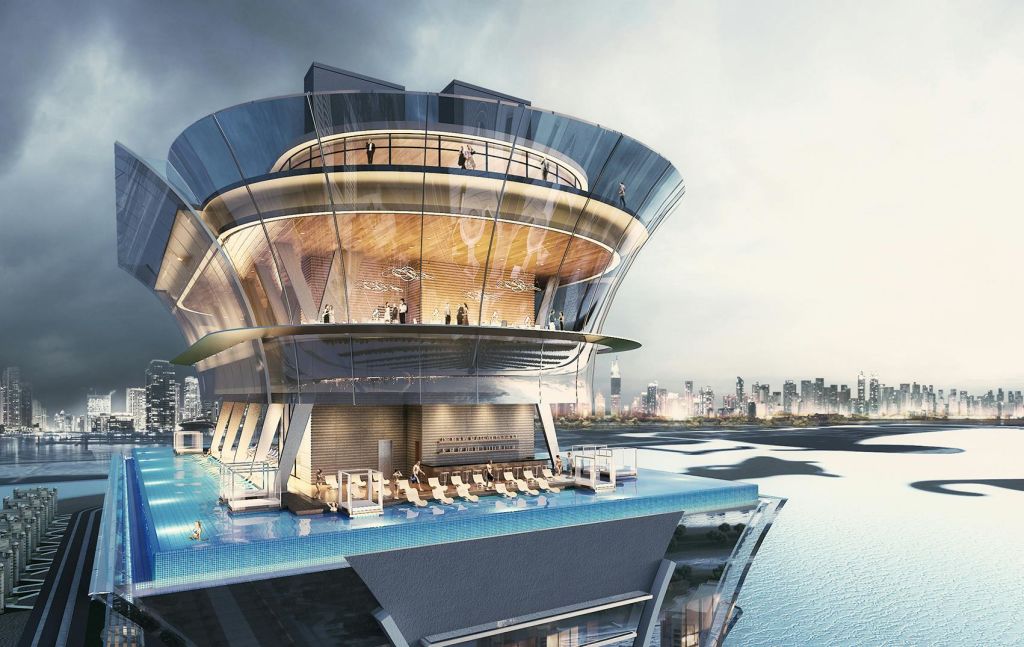 유리 벽이 있는 현대적인 다층 건물은 높은 수영장, 라운지 공간, 전망을 즐길 수 있는 사람들을 갖추고 있습니다.