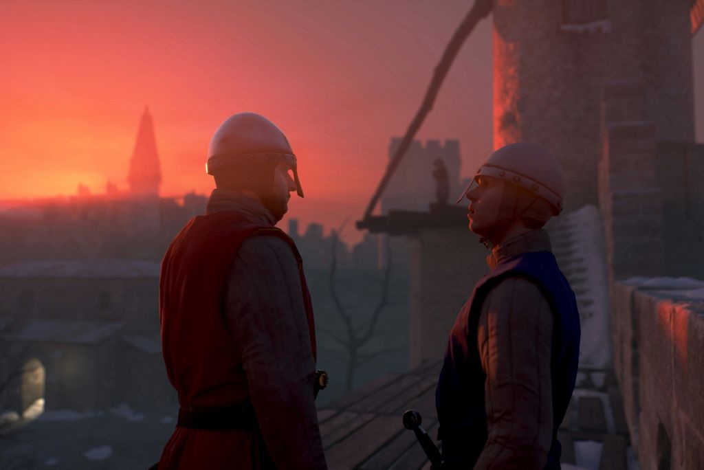 석양이 질 무렵 기갑 중세 군인 두 명이 옥상에 서 있으며, 탑에는 저 멀리 보이는 형상과 도시 스카이라인이 배경을 이루고 있습니다.