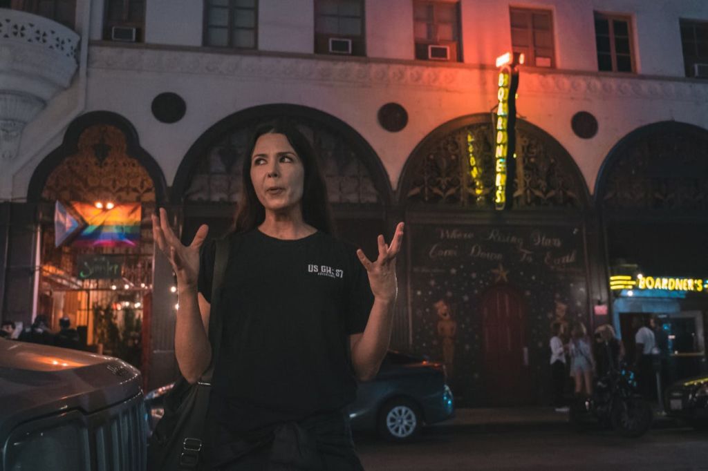 A tour guide is sharing stories in the streets of LA.