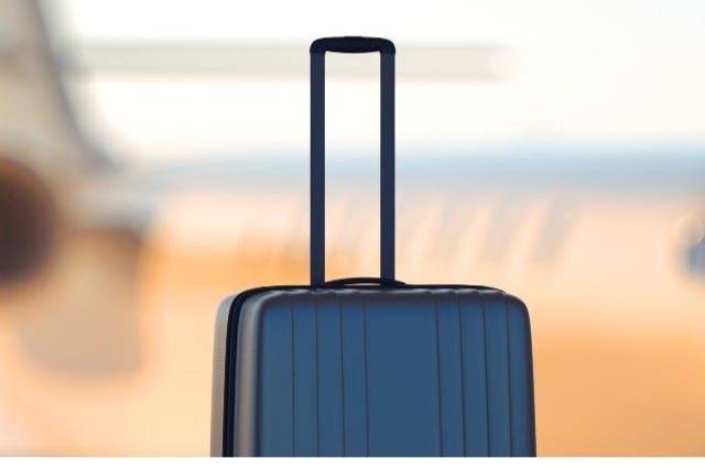 Someone carrying their luggage