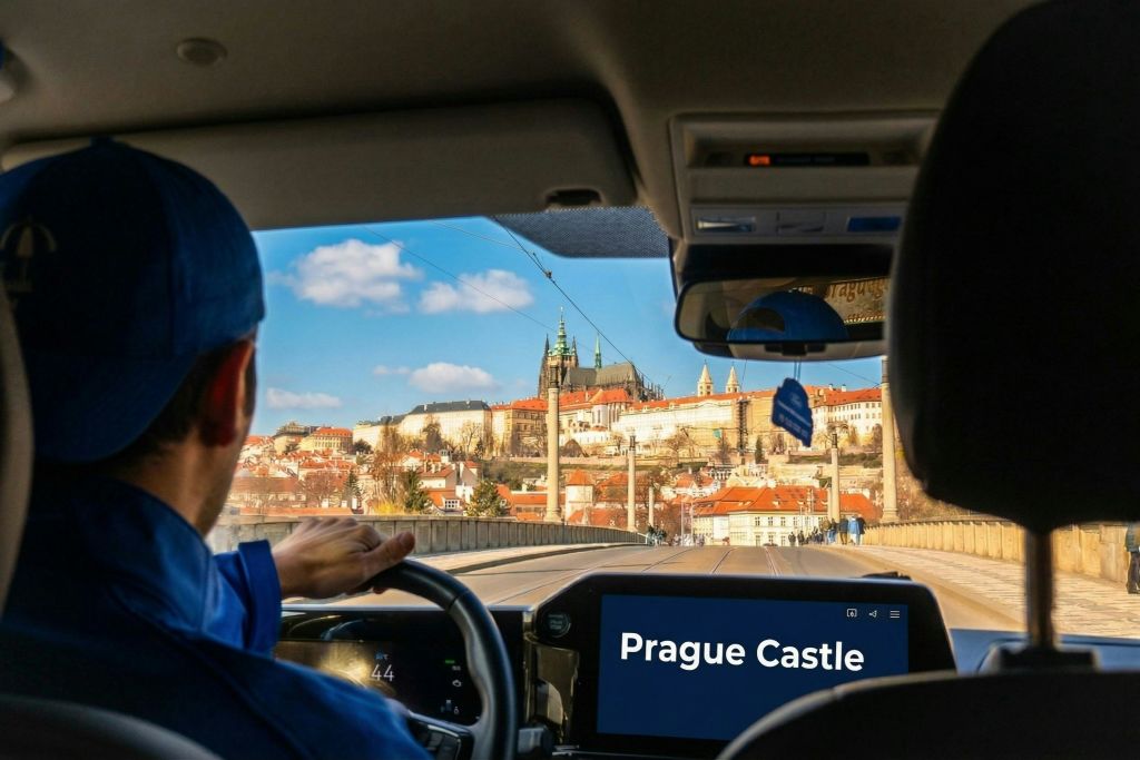 저 멀리 프라하 성이 보이는 차량 내부의 모습과 대시보드에 '프라하 성' 이 표시됩니다.