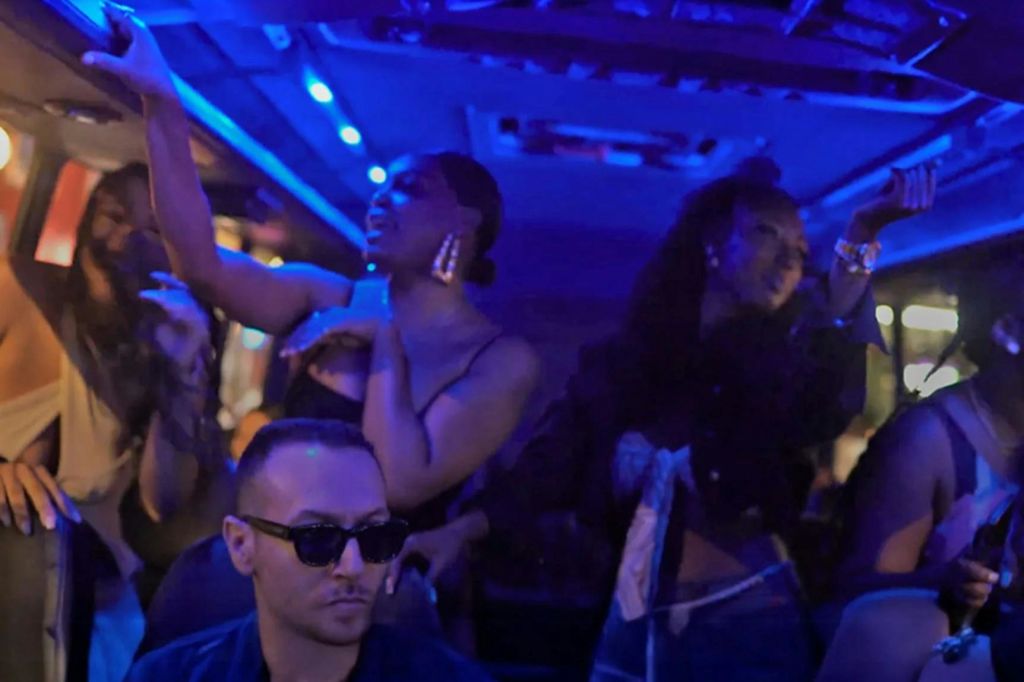 사람들은 조명이 희미한 파티 환경에서 파란색 조명 아래에서 춤을 추며 즐거운 시간을 보냅니다.