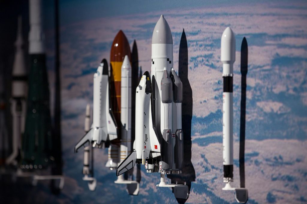 벽에 설치된 모형 로켓과 우주 왕복선은 푸르고 하얀 하늘을 배경으로 그림자를 드리웁니다.