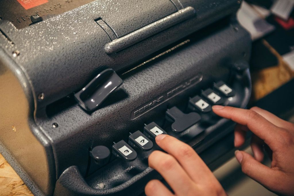 점자 기계에 입력하는 방문자.